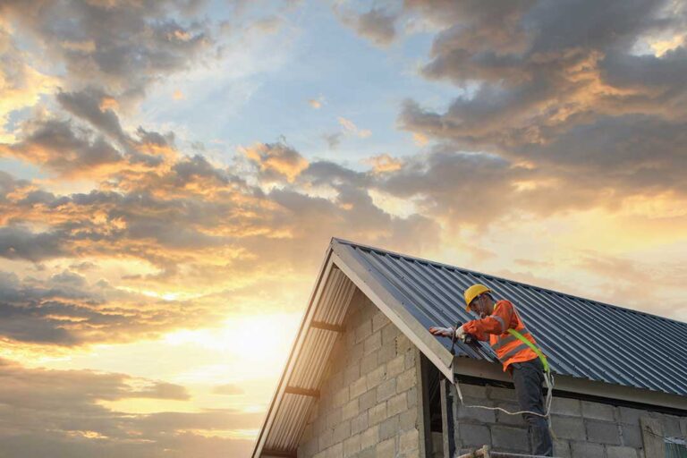 Homeowner examines a roof with binoculars beside a ladder, gloves, tools, and a gutter scoop.
