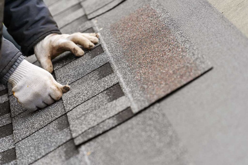 Homeowner checks roof and gutters from the ground before leaving for vacation.